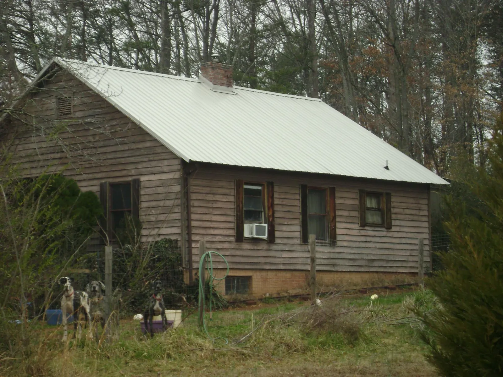 White metal roof on an old wood sided farmhouse, from a Metal Roof Installation job in Mayville