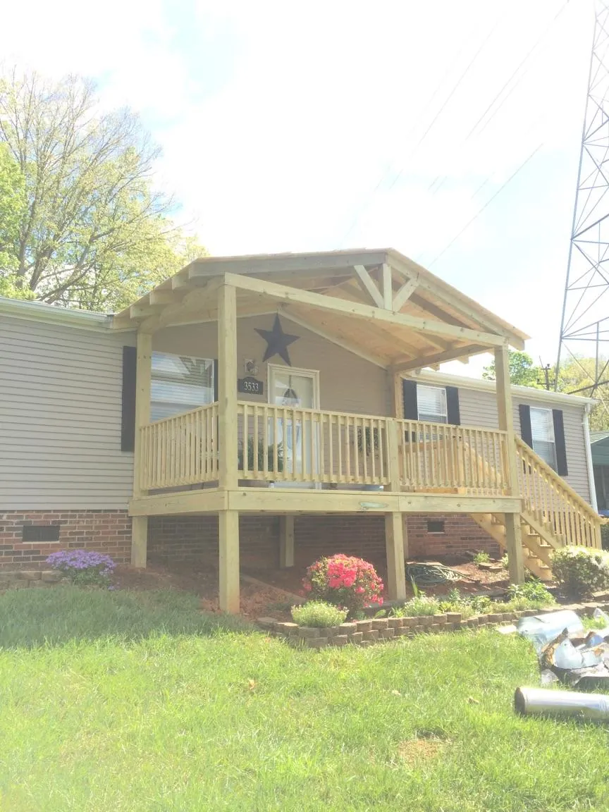 New gabled porch roof and deck railing added to a ranch home in Mayville